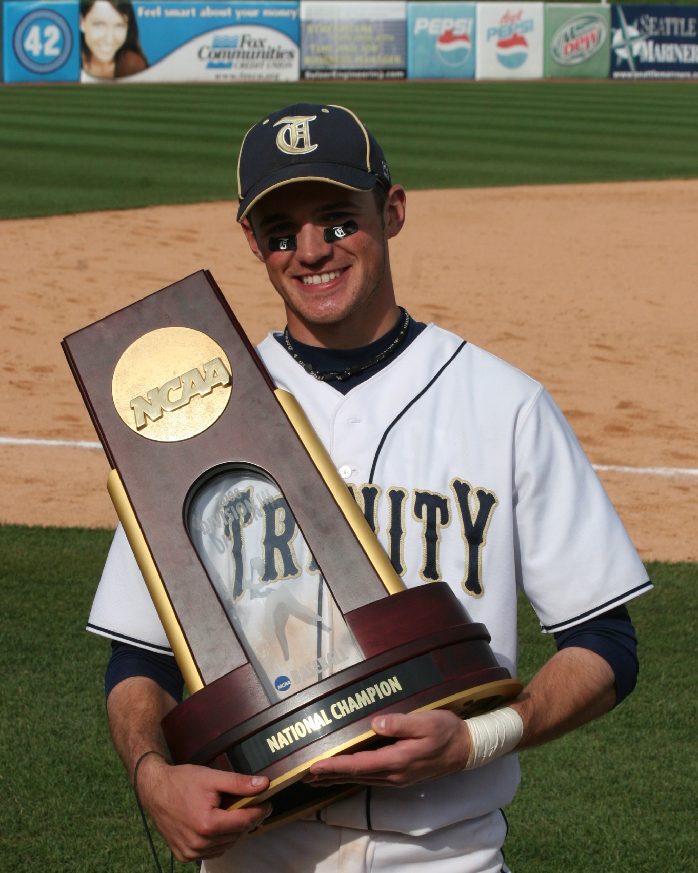 Matt Sullivan holding the 2008 NCAA Division III national championship trophy in his Trinity College jersey